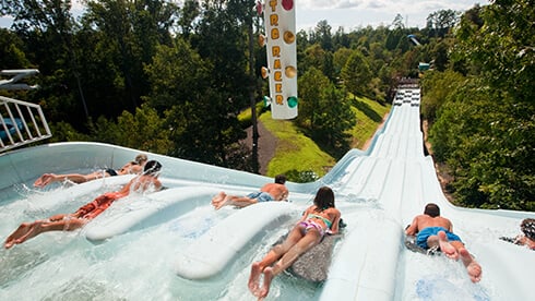 Kids sliding down Nitro Racer - High-speed slide at Water Country USA