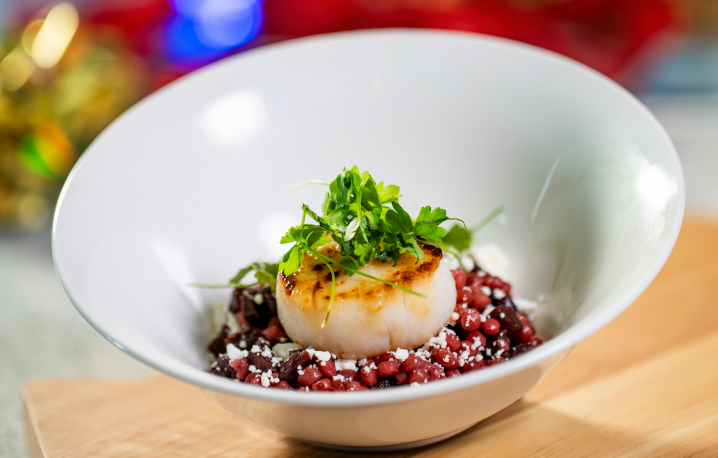 Seared Scallop, Ruby Red Couscous, and Goat Cheese Crumbles available at Busch Gardens Tampa Bay Christmas Town.