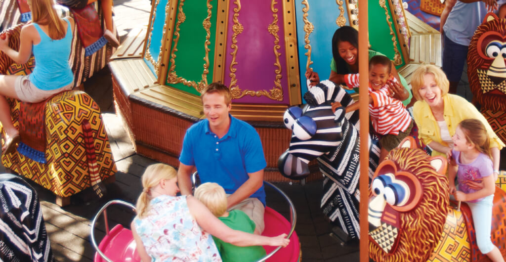 Young kids and parents alike enjoy riding a carousel at Busch Gardens Tampa Bay animal theme park, located in Florida.