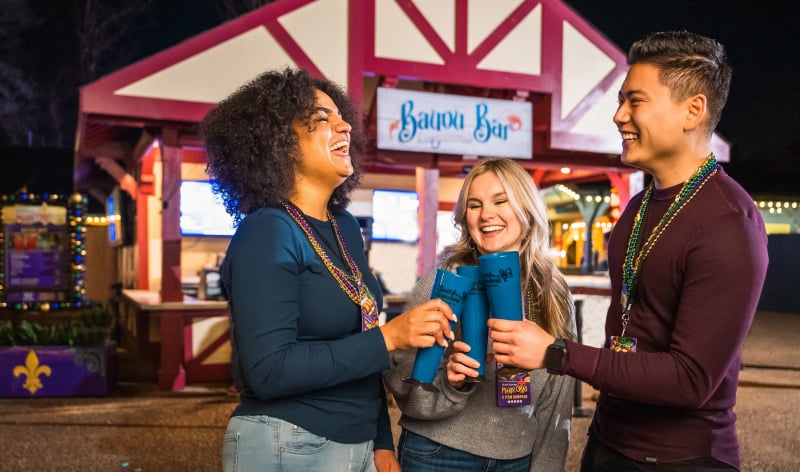 Three people having drinks outside Bayou Bar at Busch Gardens Williamsburg
