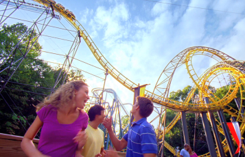A family in front of Loch Ness Monster Roller Coaster