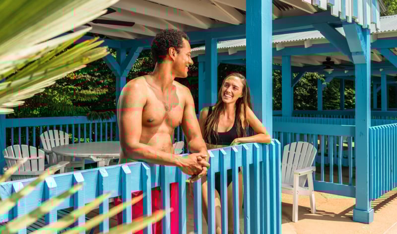Two people standing in a cabana