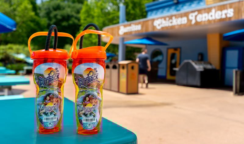 Two refillable souvenir cups on a table