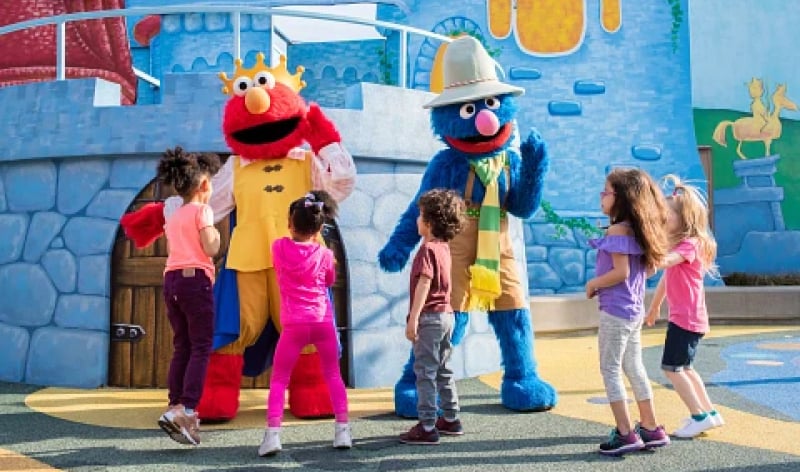 Sesame Street characters interacting with children