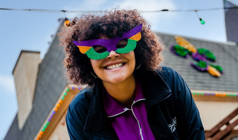 Woman wearing Mardi Gras themed glasses