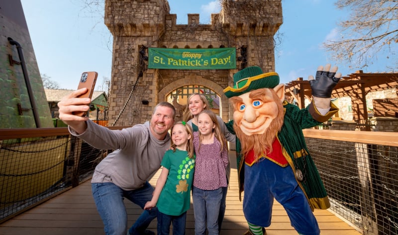A family meeting a costumed leprechaun 
