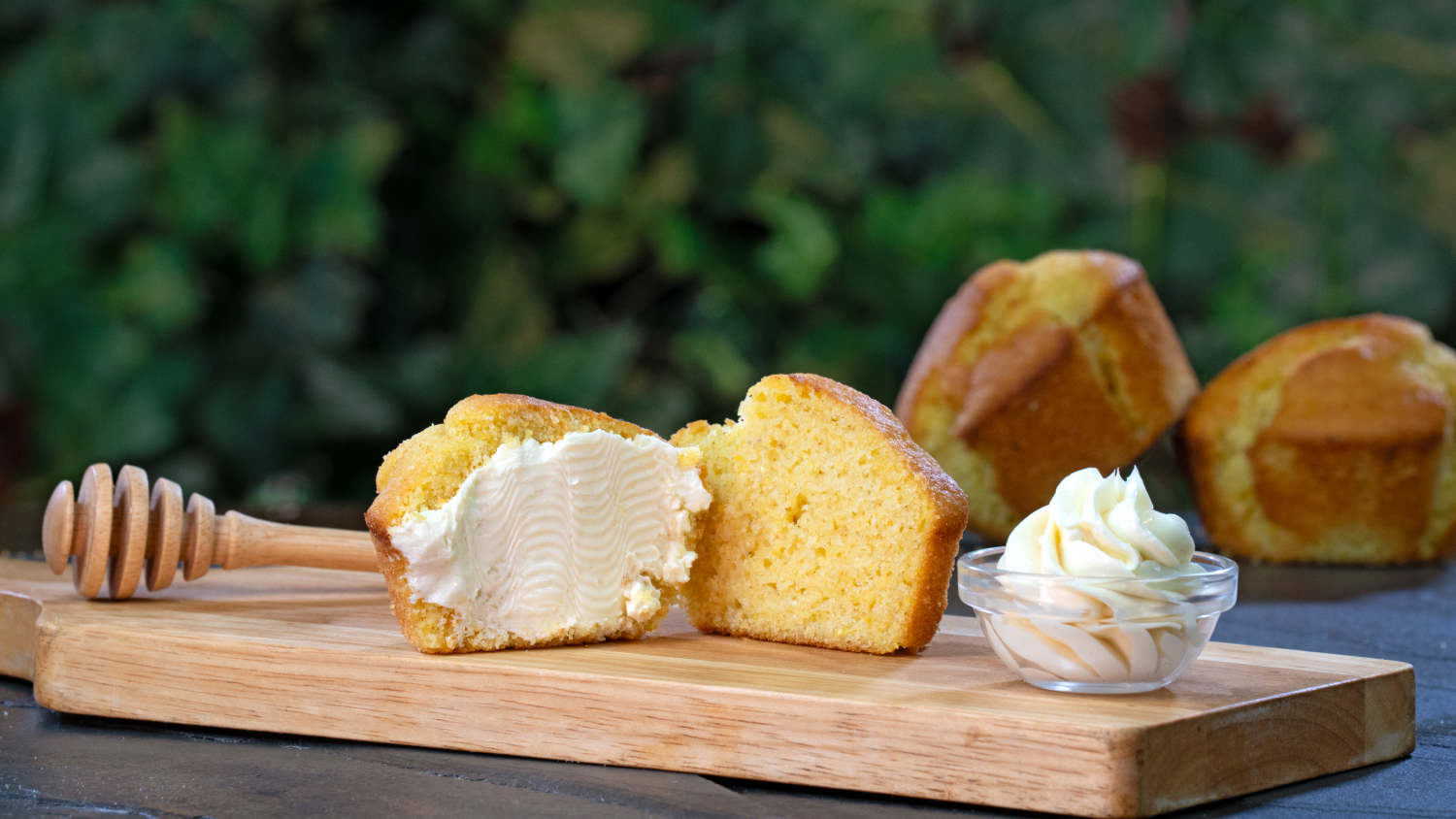 Homemade cornbread muffin served with honey butter