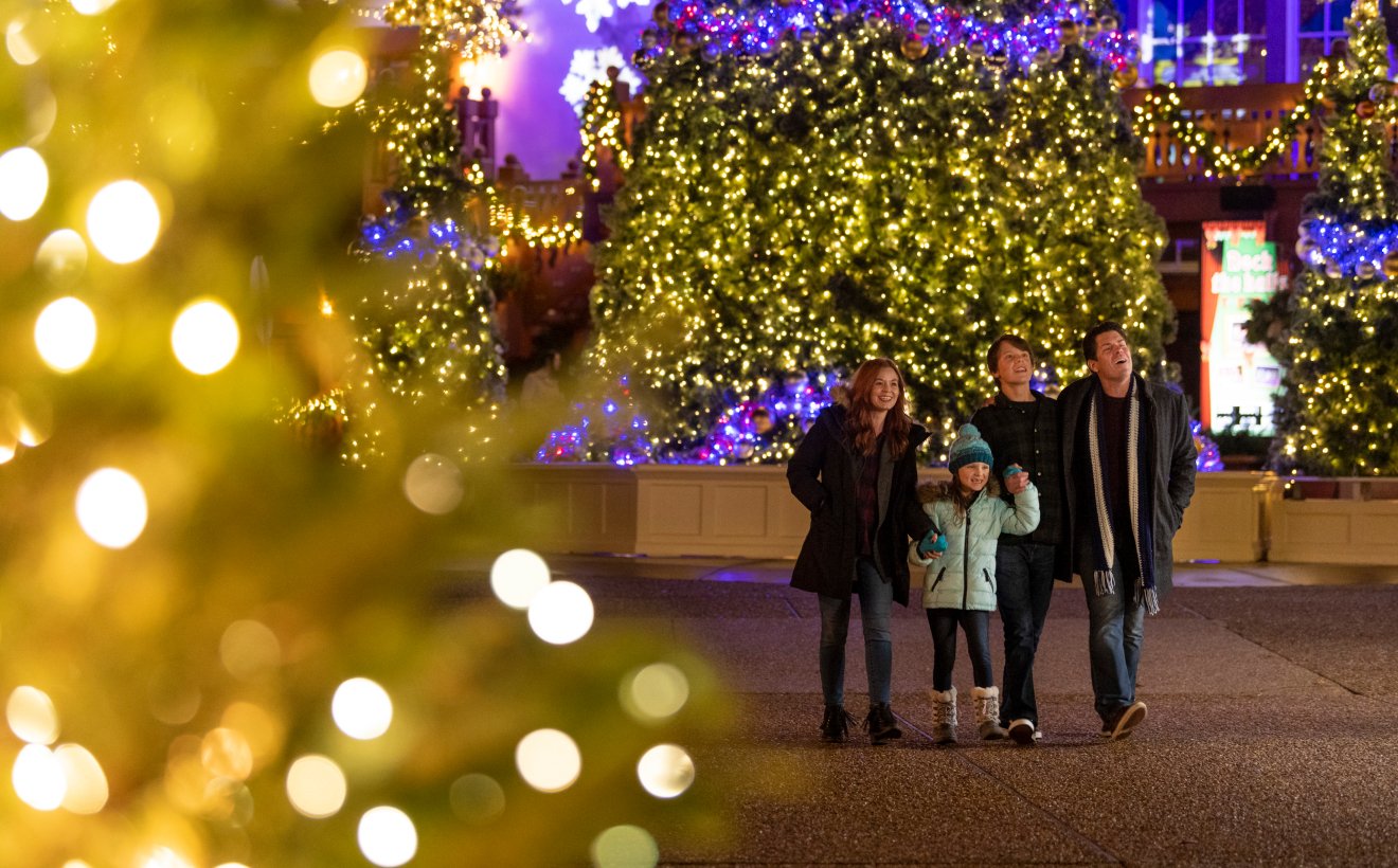 Family surround by Christmas lights