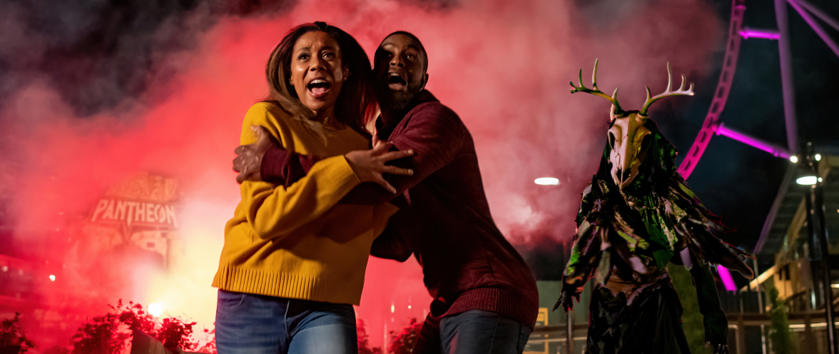 Scared couple holding each other at Howl-O-Scream