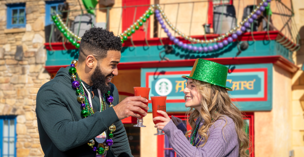Two friends with drinks during Mardi Gras