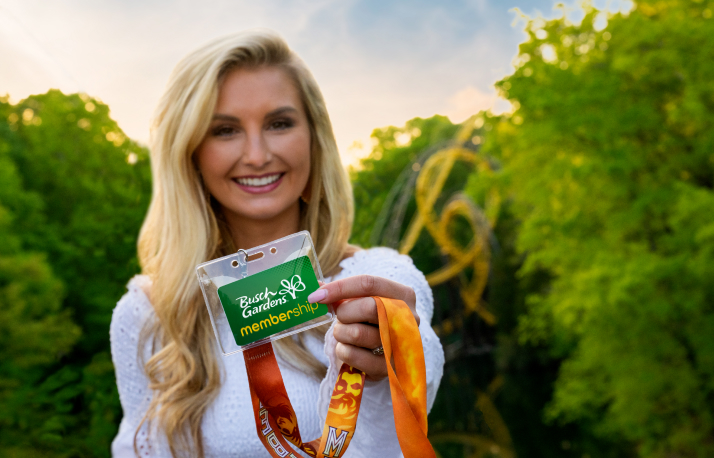 Woman holding a Busch Gardens Williamsburg Membership card