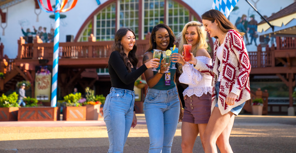 4 woman cheering with drinks in front of festhaus