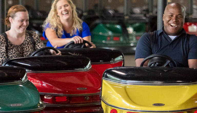 People smiling on bumper cars
