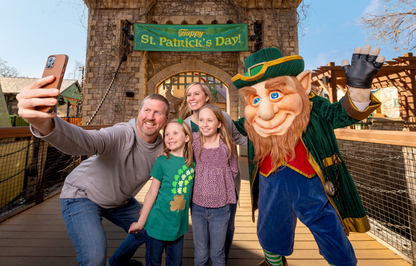 Family taking a selfie with Clancy the Leprechaun as part of the Member Appreciation Weekend at Busch Gardens Williamsburg.