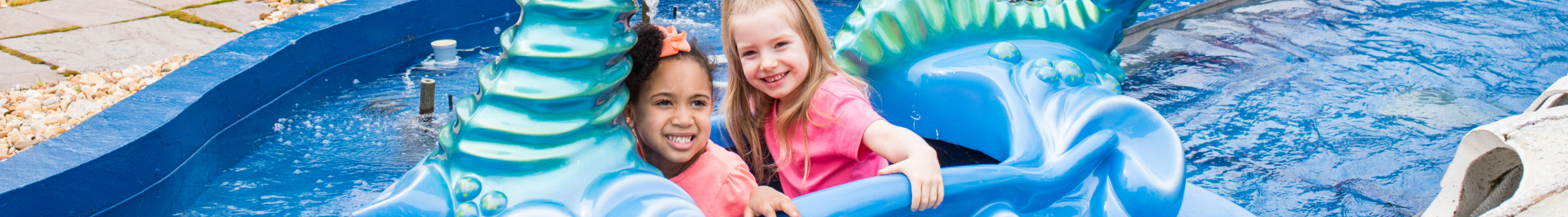 Two children on a kid friendly water flume ride