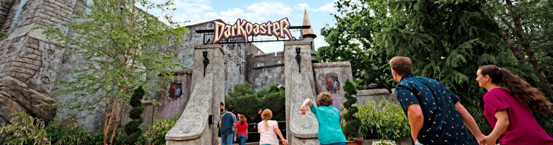 Family rushing to ride DarKoaster™ at Busch Gardens Williamsburg.