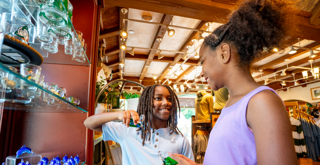 Two guest looking at a shelf of glasses