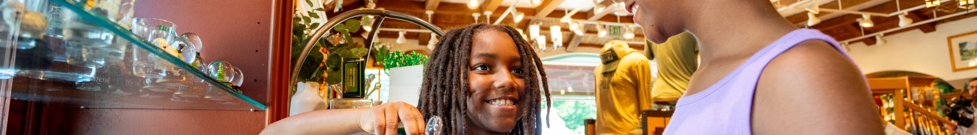 Two guest looking at a shelf of glasses