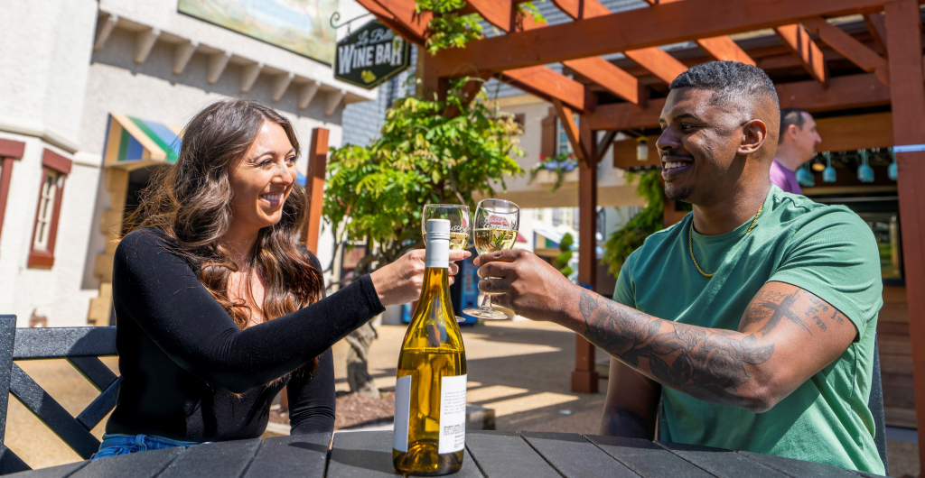 Two people clinking wine glasses