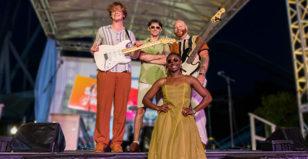 Four band members on a stage