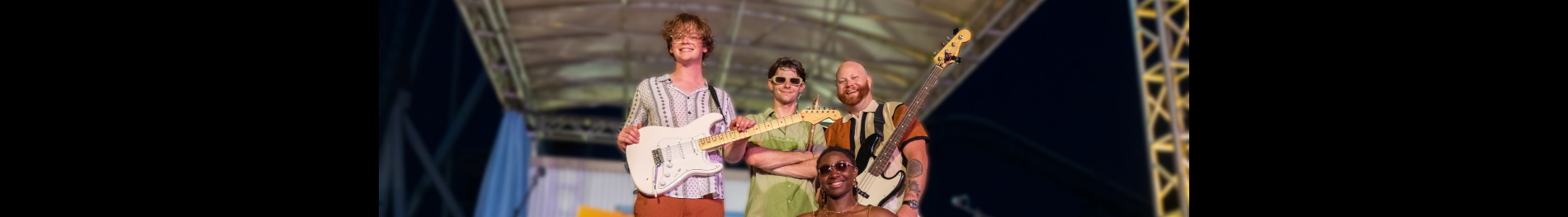 Four band members on a stage