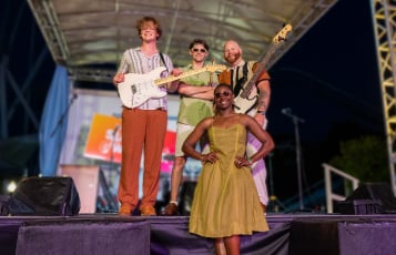 Four band members on a stage