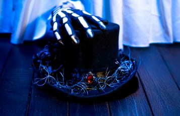 Skeleton hand on a top hat