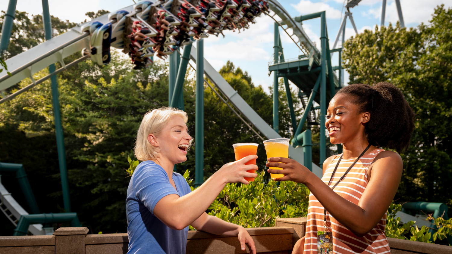 Friends enjoying brews in front of Alpengeist during Bier Fest at Busch Gardens Williamsburg.