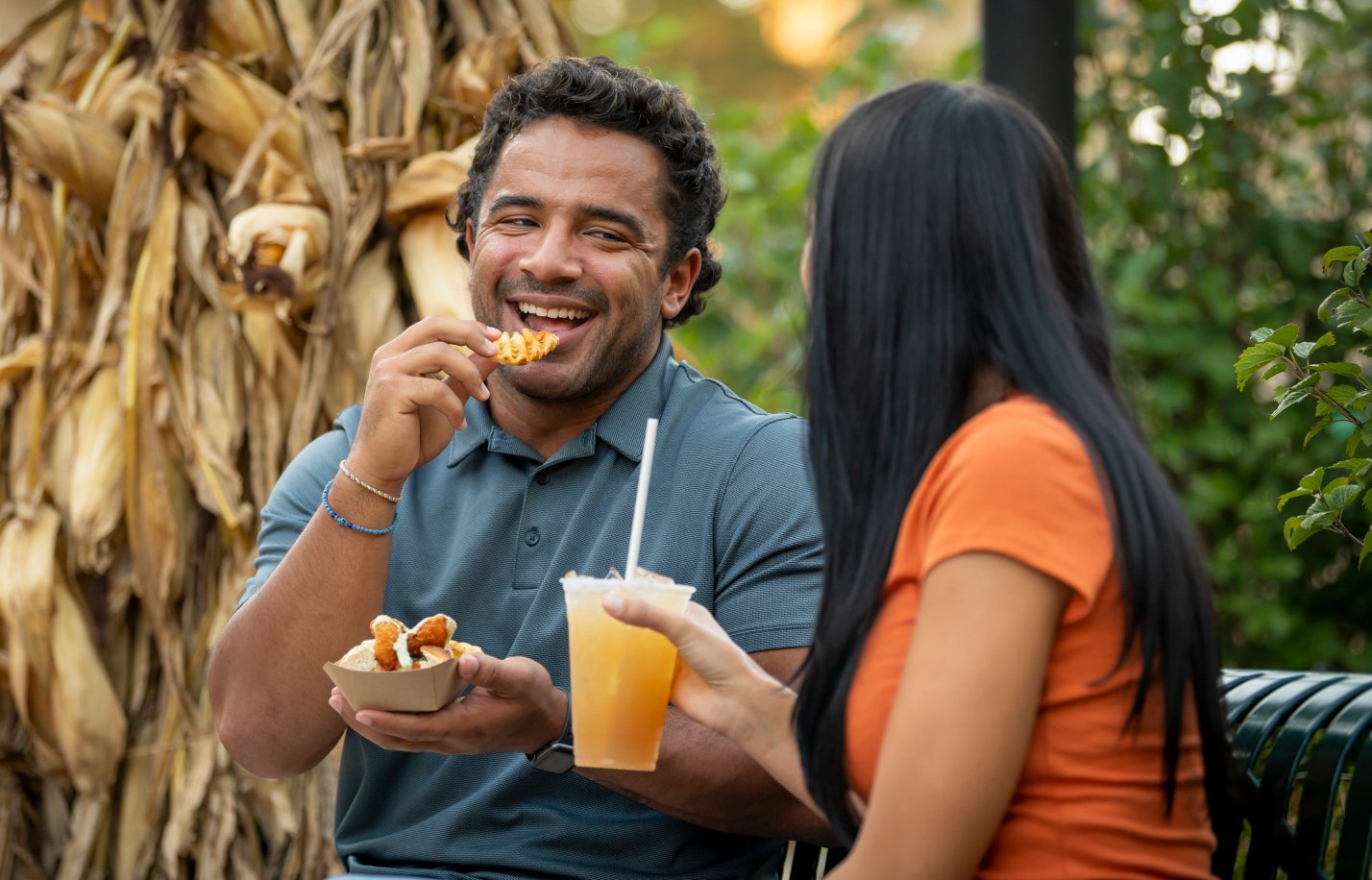 Two people enjoying the Everyone Eats Free Vacation package at Busch Gardens Williamsburg.