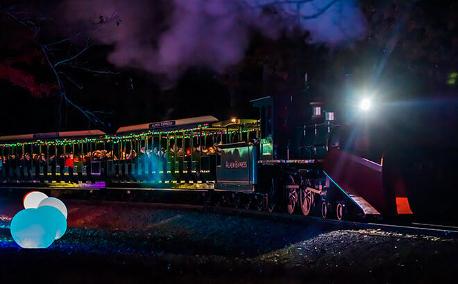 Lighted holiday train experience on the Christmas Town Express at Busch Gardens in Virginia