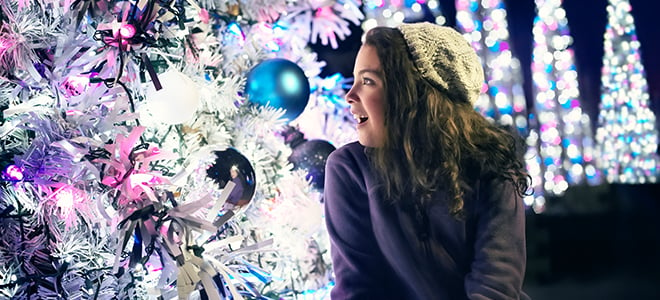 Girl admiring bright Christmas trees at Busch Gardens Williamsburg