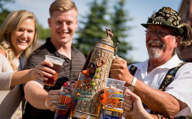 Guests raising a glass of beer to toast at Bier Fest
