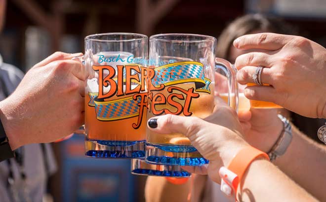 Group of guests raising a glass of beer to cheers at Bier Fest