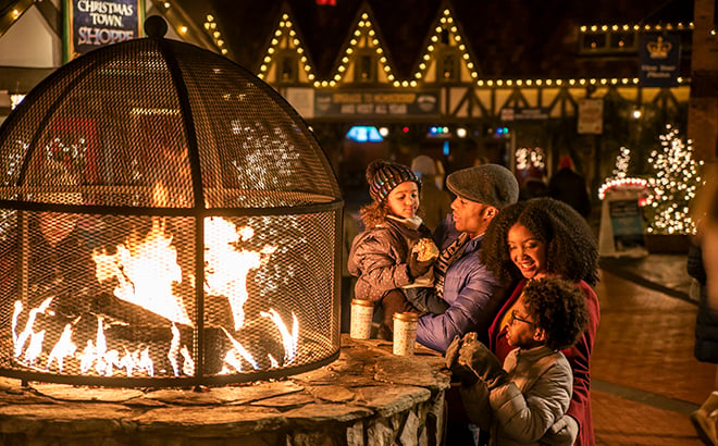 Family around a Fire pit in Germany during Christmas Town at Busch Gardens Williambsurg