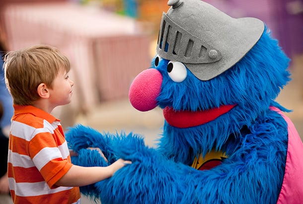 Grover greets young child at Busch Gardens Williamsburg Sesame Street Kids Weekends